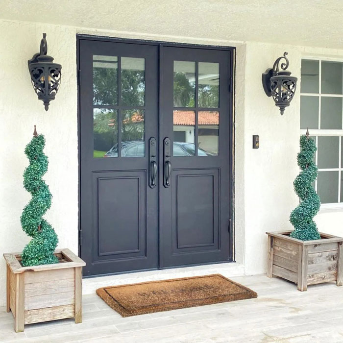 A front patio door with two decorative planters on a welcoming porch in Oklahoma City, OK
