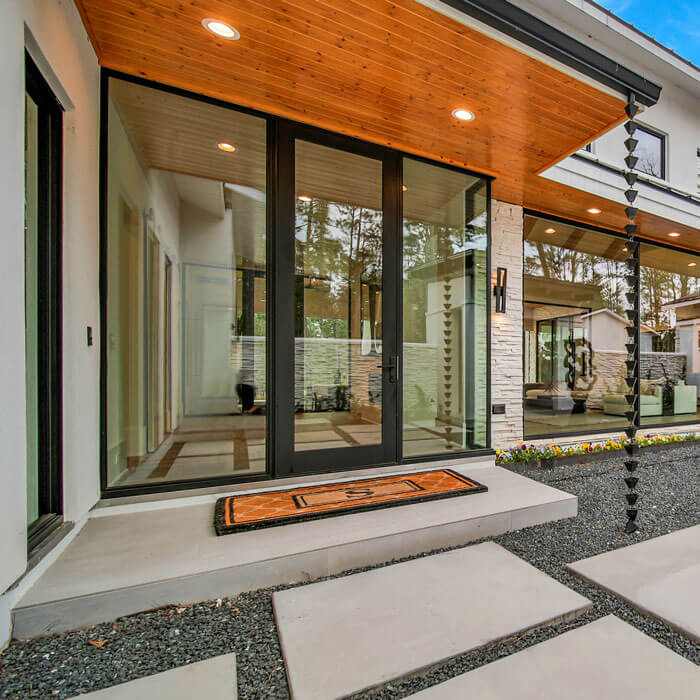 A contemporary home featuring a spacious glass door as the main entrance in Oklahoma City, OK
