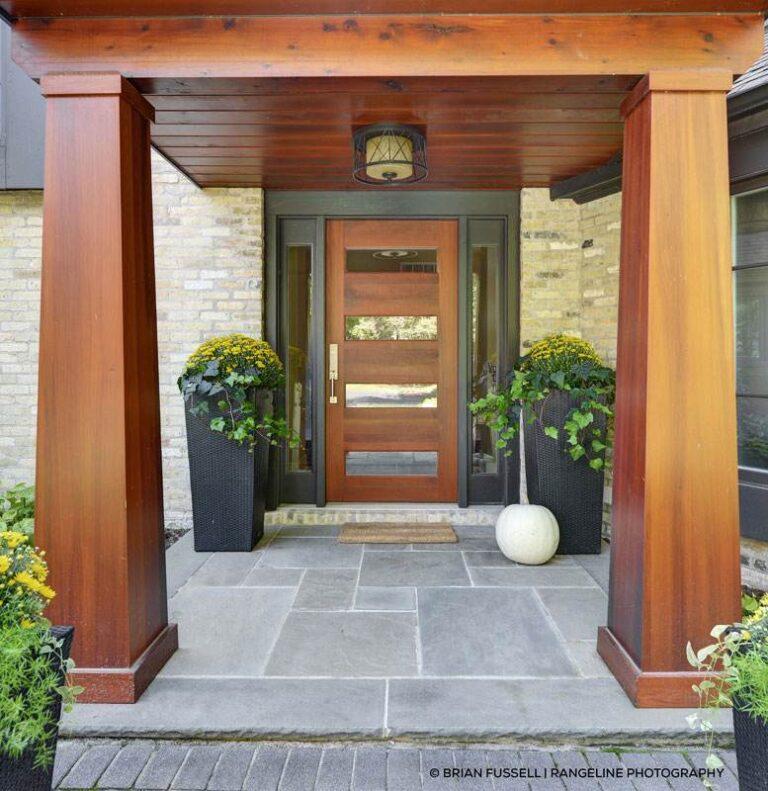 Wooden front door with a large potted plant, located in Oklahoma City, OK